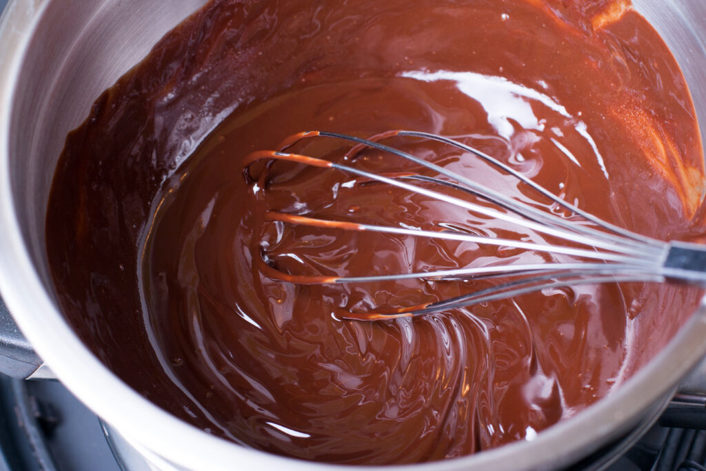 a bowl with chocolate cake batter being whisked together