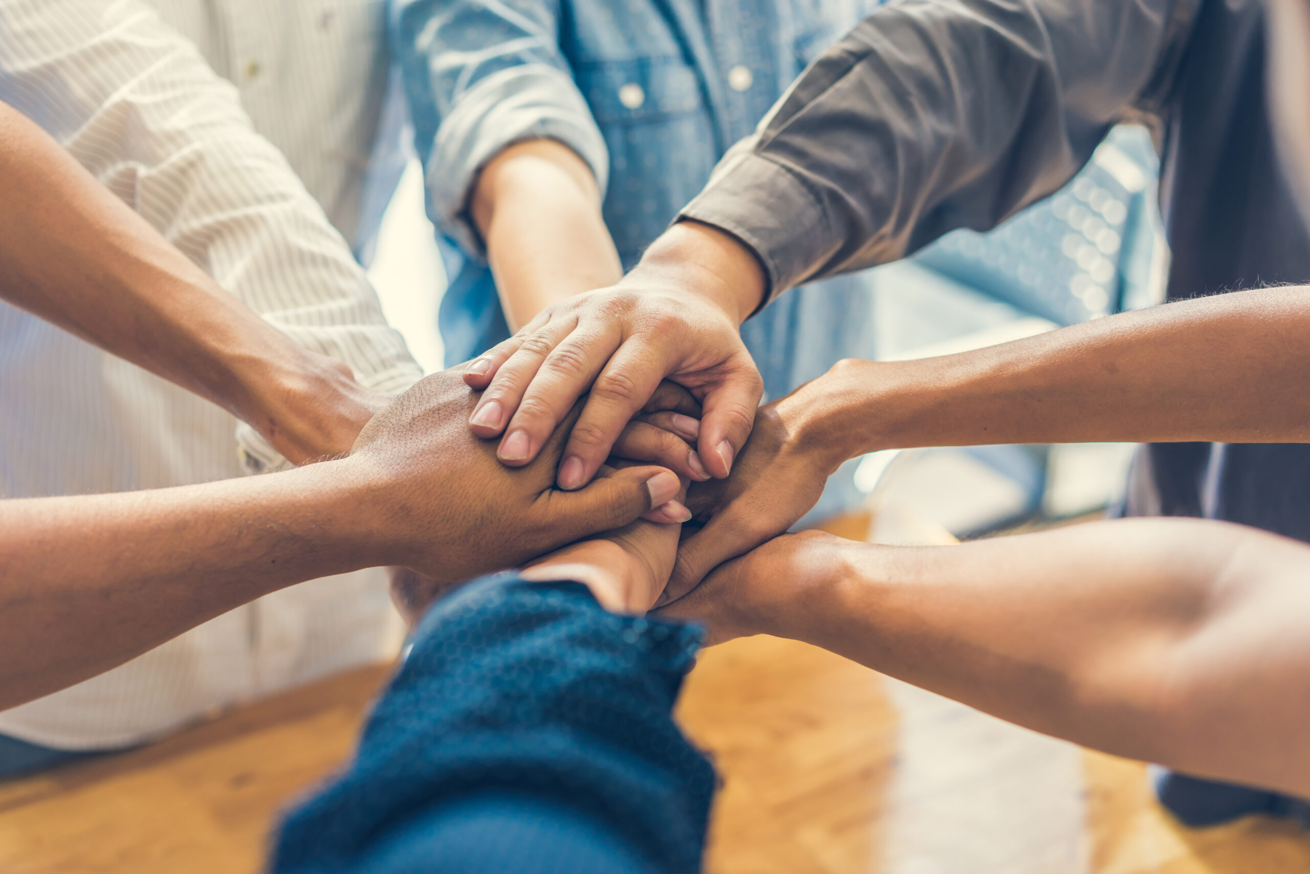 people making a pile of hands