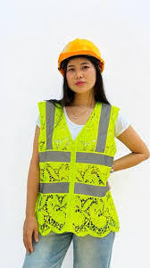 a photo of a woman in a safety vest and hard hat but the neon yellow safety vest is made of lace